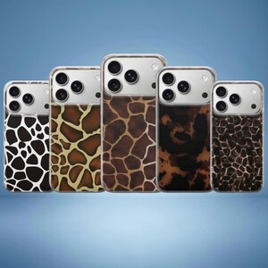 May include: Five phone cases with animal print designs. The cases feature a variety of patterns, including giraffe and leopard prints, in shades of brown, black, and white. The phones have a silver camera module.