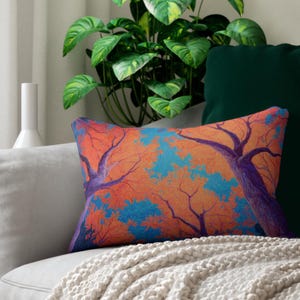 May include: Rectangular decorative pillow featuring a vibrant tree design. The pillow showcases a colorful illustration of trees with orange and blue foliage against a warm orange background. The tree trunks are purple.