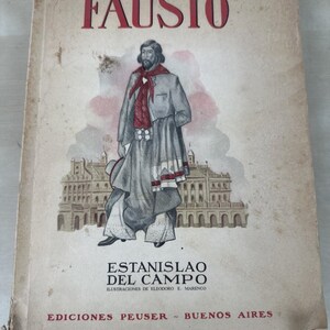 May include: A white ceramic mug with a black handle and the text "But First, Coffee" in a bold, black font. The mug is sitting on a wooden surface. The mug is 4 inches tall.