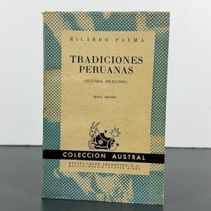 May include: A paperback book titled Tradiciones Peruanas by Ricardo Palma, Segunda Selección, Sexta Edición. The cover is tan with a teal blue halftone pattern border, a black goat illustration, and the text Coleccion Austral.