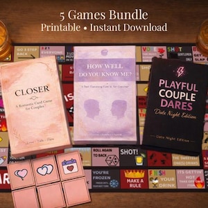 May include: A collection of romantic games for couples, including card games and a date night edition, displayed on a game board. The games are titled "Closer", "How Well Do You Know Me?", and "Playful Couple Dares". The image includes candles and snacks.