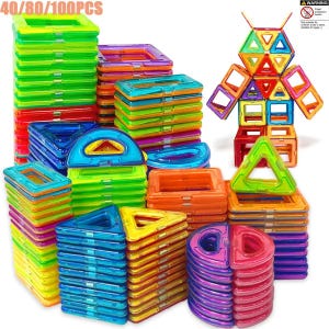 May include: A collection of colorful translucent magnetic building tiles in various geometric shapes including squares, triangles, and semicircles, stacked in piles. A robot figure is assembled from the tiles, with text 40/80/100PCS visible.