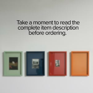 A modern monochrome picture frame available in 12 color options, displayed as framed wall art in a contemporary home interior. This handmade 9x13 personalised photo frame features a custom frame design with an off-center opening ideal for Polaroid prints, making it a versatile polaroid frame and family photo frame. Perfect for gallery wall styling, Christmas gift ideas, modern home decor, and adding a stylish accent above queen bed frame or king bed frame setups.