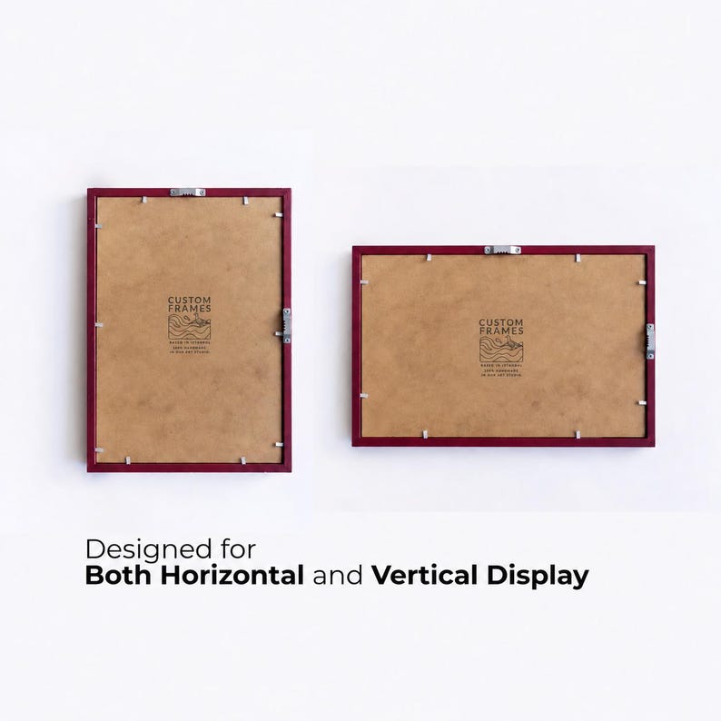May include: Two rectangular picture frames with dark red borders and brown backing boards. Each frame features metal hanging hardware and a logo with the text CUSTOM FRAMES. The text below reads: Designed for Both Horizontal and Vertical Display.
