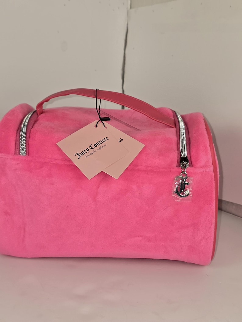 A slightly different angle of the pink velvet cosmetic bag resting on a white surface.