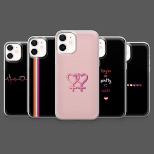 May include: A collection of phone cases with various designs. One case is pink with two interlocking Venus symbols. Other cases feature a heartbeat, a vertical stripe, the text "they're so pretty it hurts", and a row of hearts.