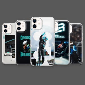 May include: Five phone cases showcasing Formula 1 driver George Russell. The cases feature images of the driver, the number 63, and his name. The cases have a clear, glossy finish, offering protection and a stylish design.