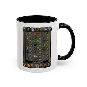 May include: White ceramic mug with a black interior and handle. The mug displays a detailed graphic of a game interface with various icons and the text "Total level: 2376".