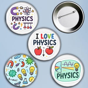 May include: A collection of five white round buttons with physics-themed designs. The buttons feature text like "PHYSICS" and "I LOVE PHYSICS", along with illustrations of atoms, magnets, and light bulbs. One button is blank.