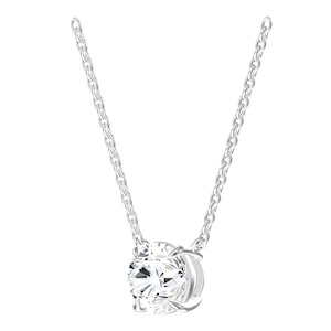 May include: A silver-toned necklace featuring a single round, clear, faceted stone set in a four-prong metal setting. The pendant is suspended from a delicate, matching silver-toned cable chain with uniform links, creating a classic, reflective appearance.