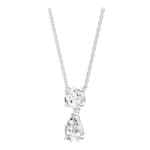 May include: A silver-toned necklace featuring a delicate chain and a dual-pendant design. The upper pendant is a round, clear faceted stone in a prong setting, while the lower pendant is a clear, pear-shaped faceted stone suspended below it.