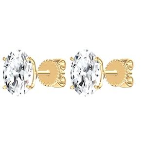 May include: A pair of stud earrings featuring oval-cut clear stones set in yellow gold prongs. Each earring includes a straight post and a round, textured yellow gold backing, showcasing a classic design with reflective facets and metallic finish.