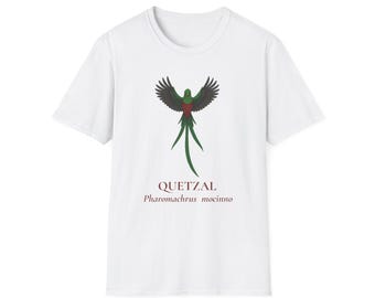 May include: White t-shirt featuring a stylized illustration of a Quetzal bird with outstretched wings. The bird is depicted in shades of green, red, and black, with the word "QUETZAL" and the scientific name "Pharomachrus mocinno" printed below.