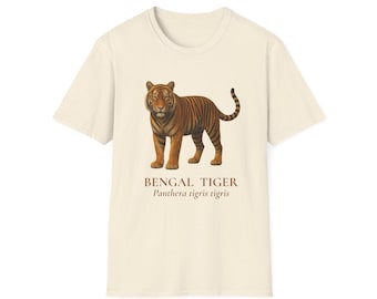 May include: Cream-colored t-shirt featuring a detailed illustration of a Bengal tiger. The tiger is depicted in shades of brown and orange with black stripes. Below the tiger is the text "BENGAL TIGER" and "Panthera tigris tigris".