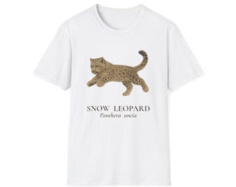 May include: White t-shirt featuring a detailed illustration of a snow leopard in a running pose. The text "SNOW LEOPARD Panthera uncia" is printed below the image. The design showcases the animal's spotted coat.