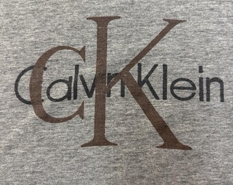 Camiseta Calvin Klein vintage gris para hombre, talla L, sin etiqueta. Medidas incluidas.