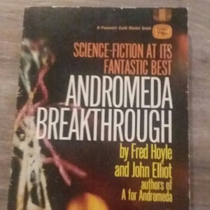 May include: A book cover with a dark background and a blurry image of a sunset. The title is "Andromeda Breakthrough" by Fred Hoyle and John Elliot, authors of "A for Andromeda".