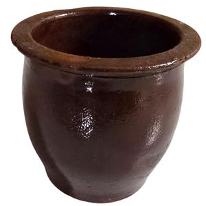 May include: A dark brown, glazed ceramic pot with a wide, rounded rim and a deep, hollow interior. The exterior surface features a smooth, reflective finish with subtle variations in color tone, showcasing a simple, functional, and sturdy design.