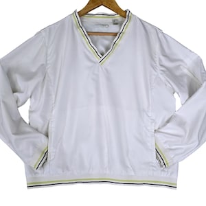 May include: A white long-sleeve pullover jacket featuring a V-neckline with lime green and black striped trim. The jacket includes a white mesh interior lining, long sleeves with matching striped cuffs, and a striped hemline at the bottom edge.