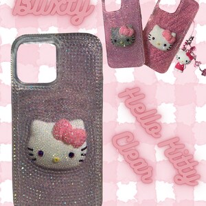 May include: Pink and clear phone cases with Hello Kitty designs. One case is covered in rhinestones, while others feature a Hello Kitty face with a pink bow. The word "Blixity" is displayed in pink, along with the words "Hello Kitty" and "Clear".