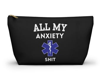 May include: Black zippered pouch with the text "ALL MY ANXIETY SHIT" in white, along with a blue medical symbol. The pouch has a gold-colored zipper and is likely made of a durable fabric.