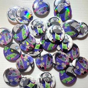 May include: A white ceramic mug with a black handle and the text "But First, Coffee" in a bold, black font. The mug is set against a blurred background, suggesting a cozy setting.