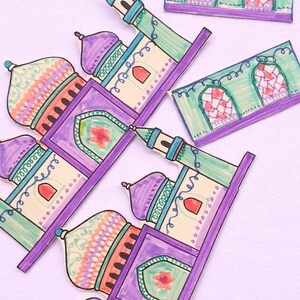 May include: Hand-drawn paper cutouts of mosques and arched windows. The mosques feature purple domes, green minarets, and cream-colored walls with red accents. The windows have stained glass patterns in red and orange.
