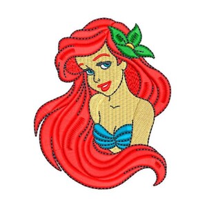 May include: An embroidered design of a mermaid with flowing red hair, blue eyes, and a turquoise seashell top. A green flower adorns her hair. The design is on a white background.