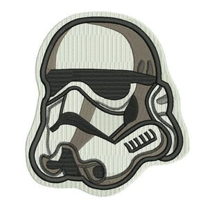 May include: Embroidered patch featuring a Stormtrooper helmet design. The patch has a white, black, and gray color scheme with detailed stitching. The helmet is outlined in black, with gray and black accents. The background is a light beige color.