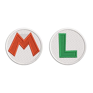May include: Two embroidered patches featuring the letters "M" and "L". The "M" is in orange, and the "L" is in green. Both letters are inside white circles with a white border, set against a white background.
