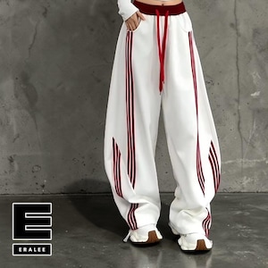 May include: White sweatpants with red stripes down the sides and a red drawstring. The pants have a wide, loose fit and are paired with white sneakers. The brand name "ERALEE" is displayed in a black and white logo.