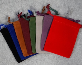 May include: Assortment of ten small velvet drawstring bags in various colors, including black, blue, orange, brown, burgundy, green, gray, purple, and red.