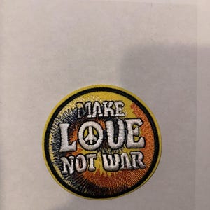 May include: A weathered wooden sign displaying the words "Welcome to our porch" in white. The sign has a distressed appearance, ideal for adding a touch of rustic charm to a porch or garden.