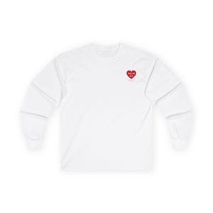 May include: White long-sleeve shirt with a red heart graphic on the upper left chest. The heart contains the text "FALLIN 4 U" and "M.S." in a smaller font. The shirt is made of a soft, comfortable material.