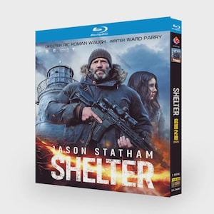 May include: Blu-ray disc for the movie "Shelter" featuring Jason Statham. The cover art shows a man holding a rifle in front of a lighthouse. The title "Shelter" is prominently displayed in large white letters.
