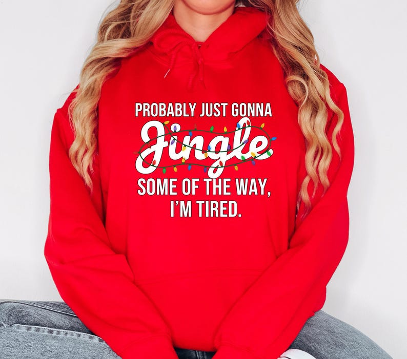 A person wearing a red hoodie with a humorous text printed on it.