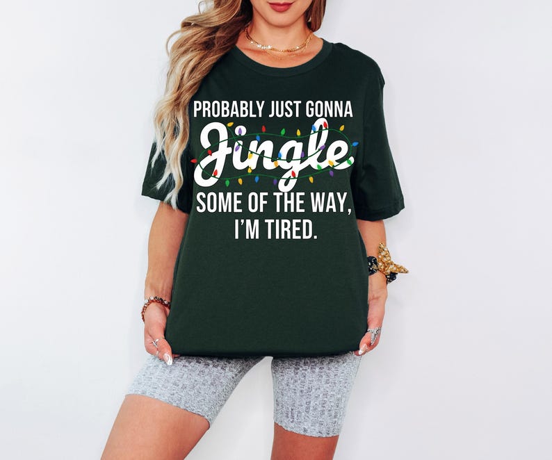 A woman wearing a green t-shirt with a humorous text printed on it.