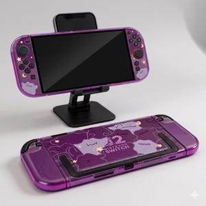 May include: A purple Nintendo Switch console and a matching protective case. The console is mounted on a black stand, and the case features a design with clouds, stars, and a character. The text "Nintendo Switch" is visible on the case.