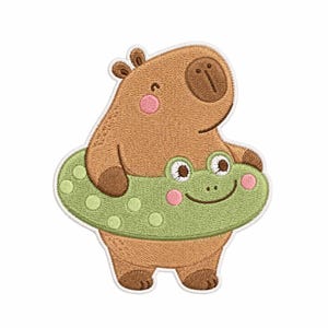 May include: An embroidered patch featuring a light brown capybara with a dark brown snout and pink cheeks. The capybara is wearing a light green, polka-dotted inflatable swim ring that resembles a frog face with two eyes and a smiling mouth.