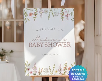 May include: A rectangular welcome sign for a baby shower featuring watercolor floral illustrations at the top and bottom. The text reads: Welcome to Madion's Baby Shower, April 12, 2026. A blue circular badge in the corner states: Editable in Canva & Instant Download.