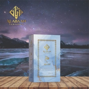 May include: A perfume box with the brand name "AL-ABAAN PERFUMES" in gold lettering. The box is light blue with a gold border and the word "Blu" in the center. The background features a starry sky and a snowy landscape.