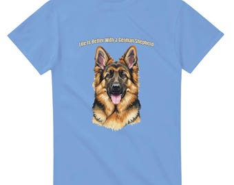 May include: Light blue t-shirt featuring a detailed illustration of a German Shepherd dog with a pink tongue. The text "Life is Better With a German Shepherd" is printed above the dog's head. The shirt is made of a soft material.