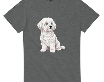 May include: Dark gray t-shirt featuring a detailed illustration of a fluffy white dog in a sitting position. The dog has a friendly expression and is centered on the shirt. The t-shirt is made of a soft material.