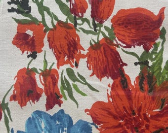 May include: A textile fabric featuring a printed pattern of vibrant orange-red bell-shaped flowers and a large, textured blue blossom. The design includes dark green stems and leaves set against a light beige, woven-textured background.