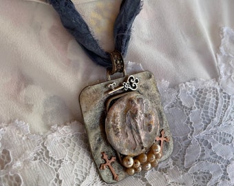 Assemblage foundobject pendant on knotted silk. Boho statement jewelry.
