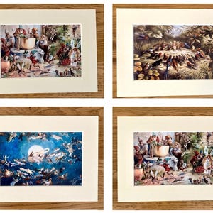 May include: Four matted art prints featuring fantasy illustrations. Two prints show gnomes and fairies in a forest setting, one depicts a bird gathering, and one shows a group of fairies flying against a dark blue night sky with a large full moon.