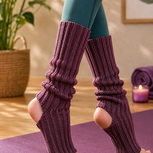 Peut inclure: Une paire de jambières en tricot côtelé de couleur prune foncé, dotées d'un design à talon ouvert et d'une construction à bout ouvert. Ces accessoires mi-mollet présentent une texture côtelée verticale allant du milieu du mollet jusqu'au pied.