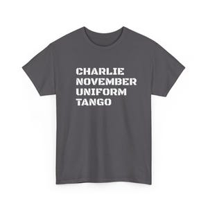 May include: A charcoal gray t-shirt with the words "CHARLIE NOVEMBER UNIFORM TANGO" printed in white, block letters. The shirt has short sleeves and a crew neck.