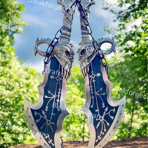May include: Two silver and blue fantasy blades with intricate designs and a chain connecting them. The blades have a skull-like design on the hilt and are set against a natural background.