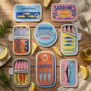 May include: A collection of eight rectangular and circular fabric coasters featuring colorful illustrations of sardine tins. Each coaster displays various sardine graphics, text labels like Sardines in Olive Oil, and pull-tab details in blue, pink, orange, and yellow.